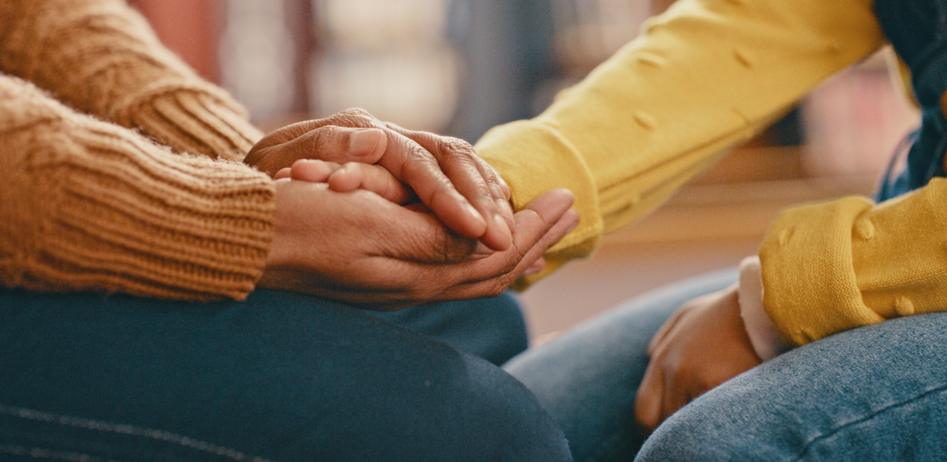 People holding hands with compassion and support